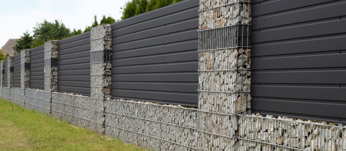 A modern form of house fencing. Gabions, steel galvanized nets filled with split stone